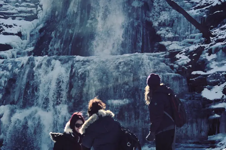 a group of people standing on top of a snow covered slope