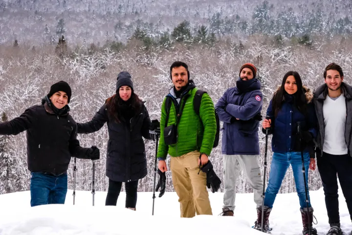 a group of people posing for a picture in the snow