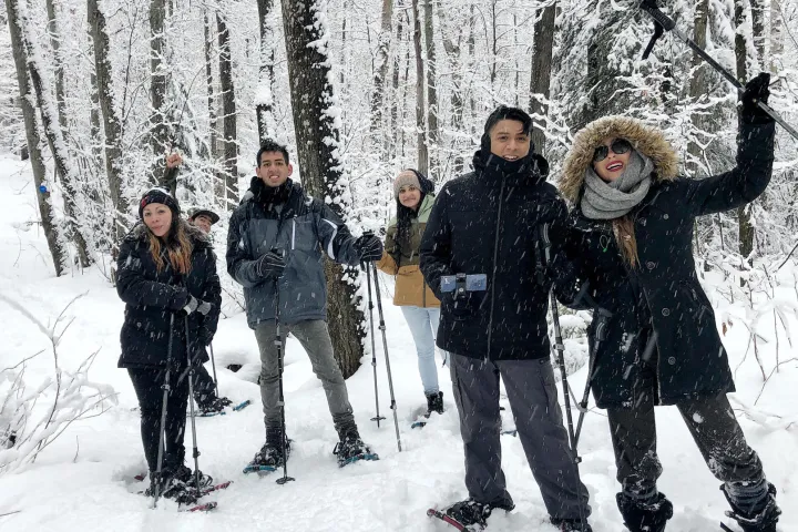 a group of people posing for a picture in the snow