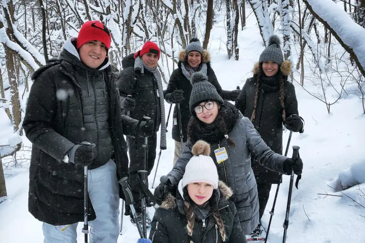 a group of people standing on top of a snow covered slope