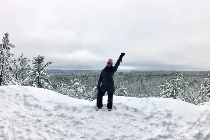 a man riding a snowboard down a snow covered slope