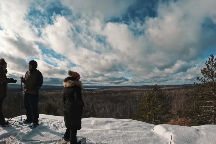 a group of people standing on top of a snow covered slope