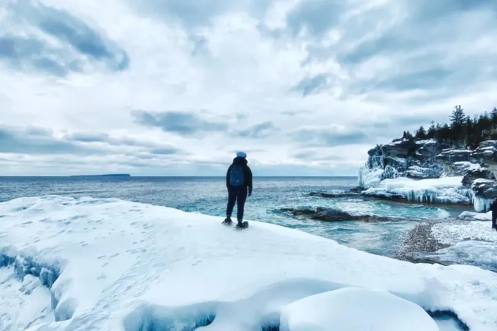 a person standing on top of a snow covered slope