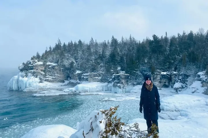 a man standing on top of a snow covered slope