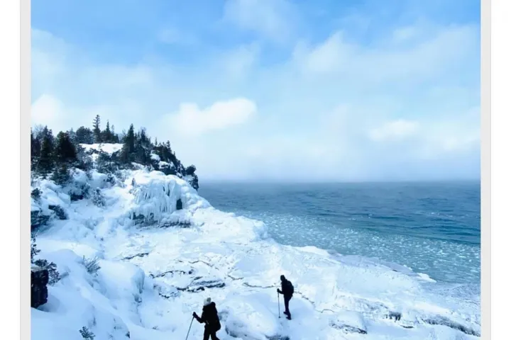 a group of people riding skis on top of a snow covered slope