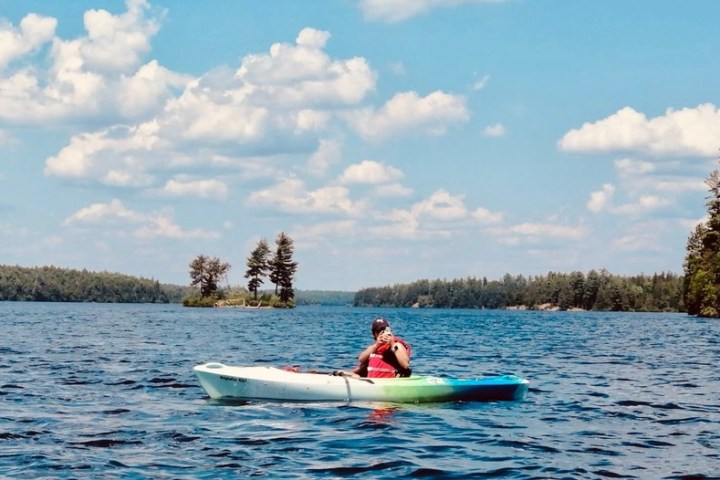 a person riding on the back of a boat in a body of water