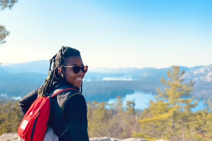 a person standing in front of a mountain