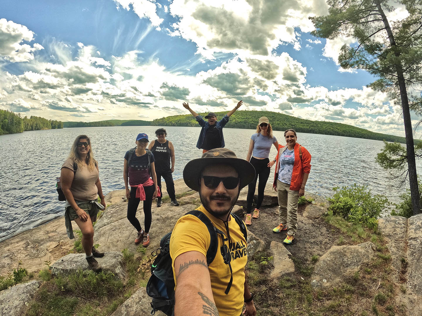 a group of people walking down a dirt road