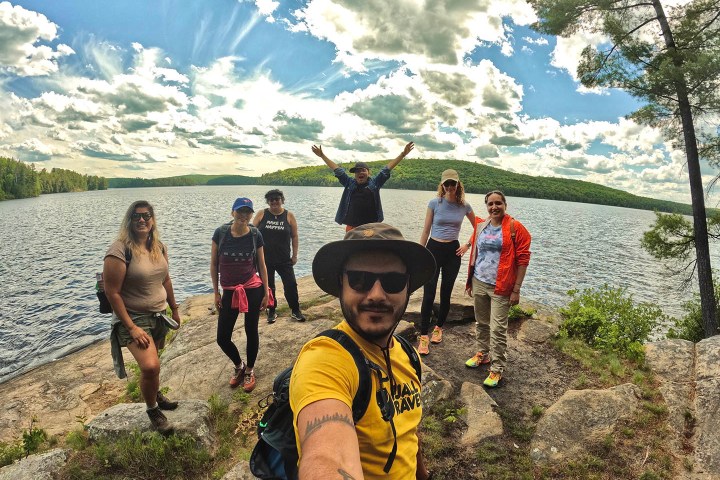 a group of people walking down a dirt road