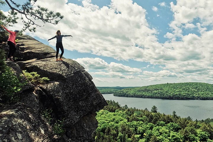 a man standing next to a body of water