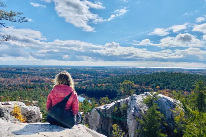 a person standing in front of a mountain
