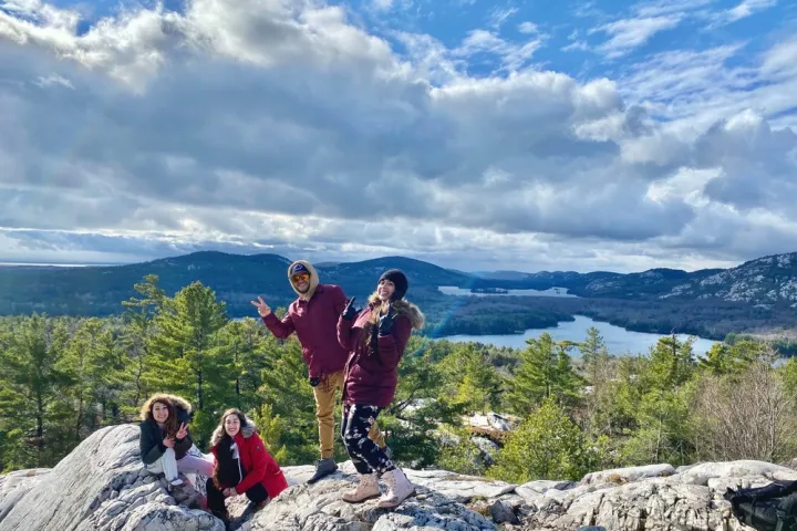a group of people standing on top of a mountain