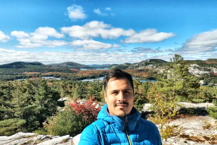 a man standing in front of a mountain