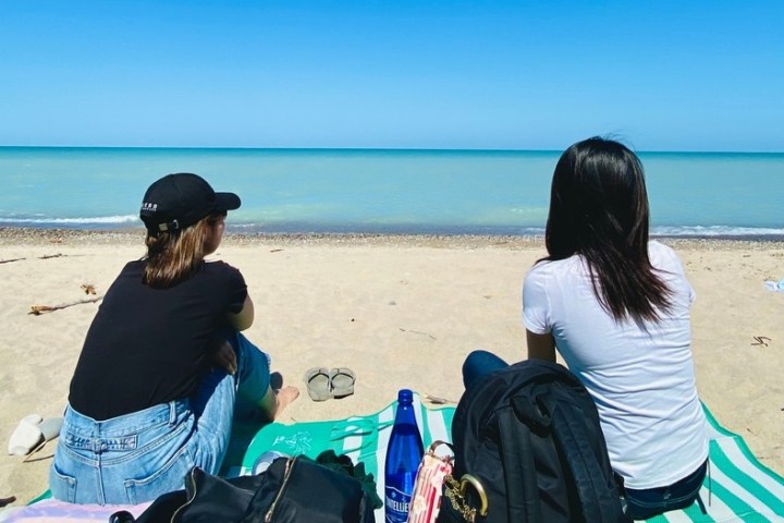 a couple of people that are sitting on a beach