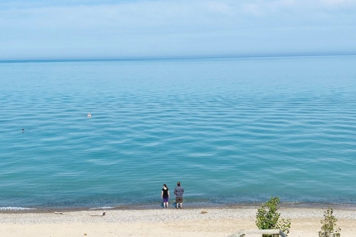 a group of people on a beach near a body of water