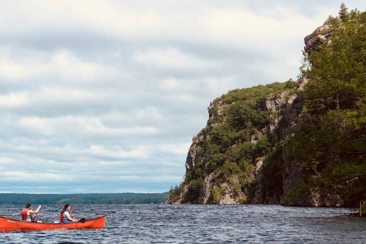 a group of people in a boat on a body of water