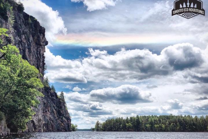 a body of water with a mountain in the background