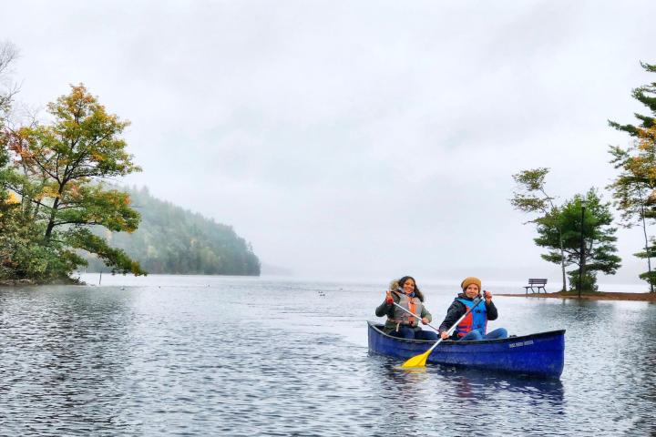 a man riding on the back of a boat in a body of water