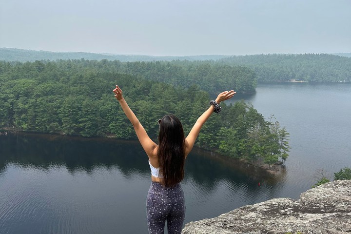a man flying through the air over a body of water