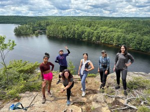 a group of people standing next to a body of water