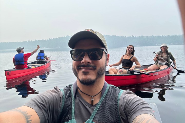 a man and a woman sitting on a boat in the water