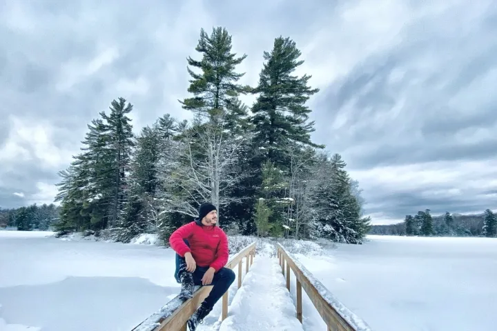 a man riding skis down a snow covered slope