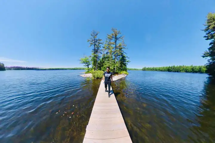 a boat traveling along a river next to a body of water