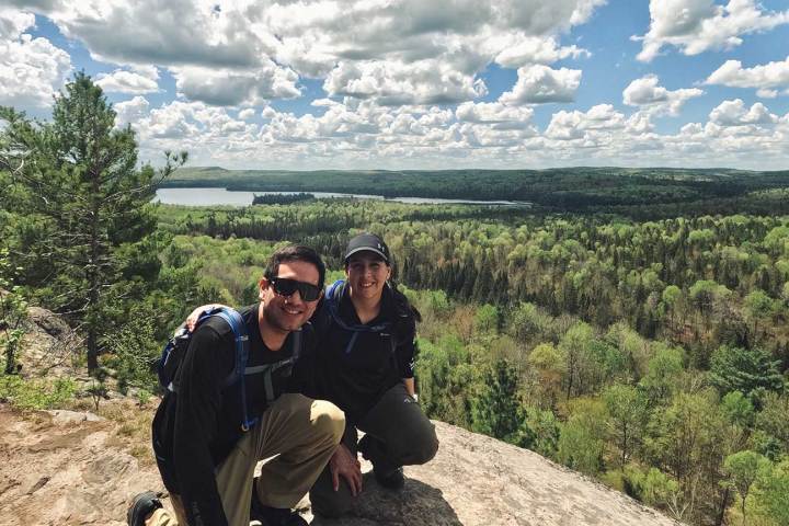 a man sitting on top of a mountain