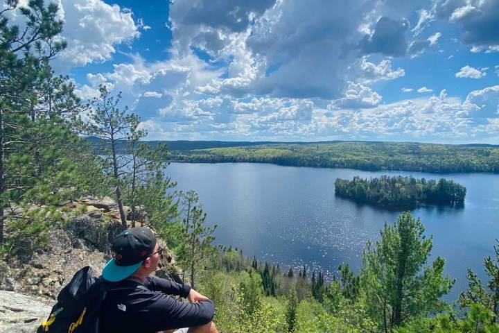 a man sitting on the side of a mountain