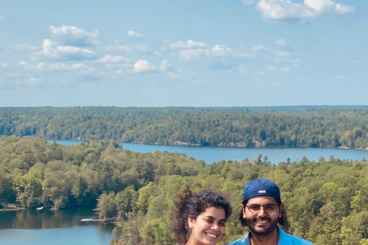 a man standing next to a body of water