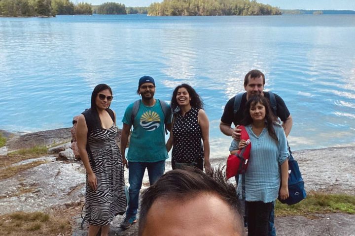 a group of people standing next to a body of water