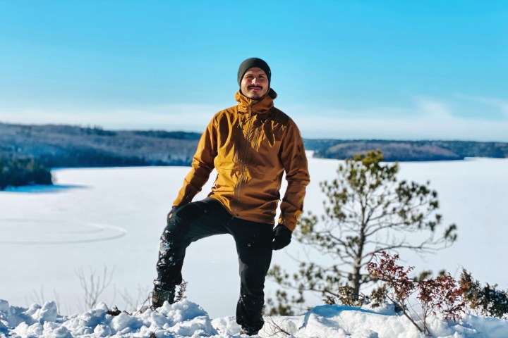 a man standing on top of a snow covered field