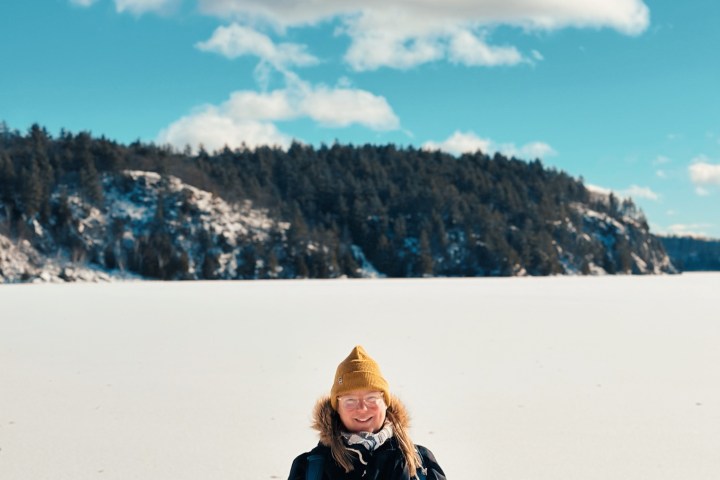 a woman standing on a snow covered slope