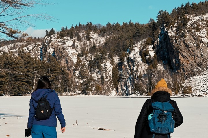 a group of people standing on top of a snow covered slope