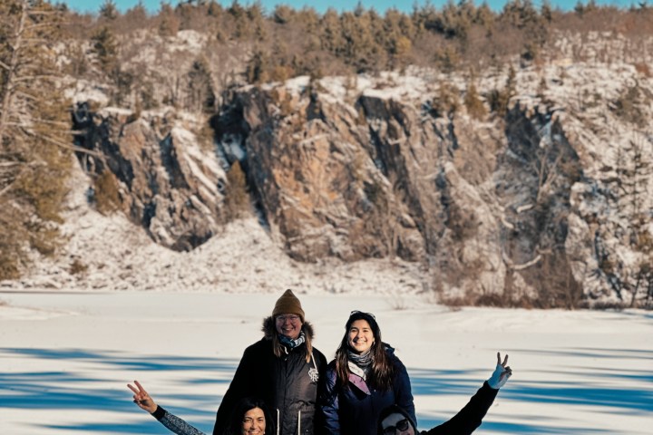 a group of people standing on top of a mountain