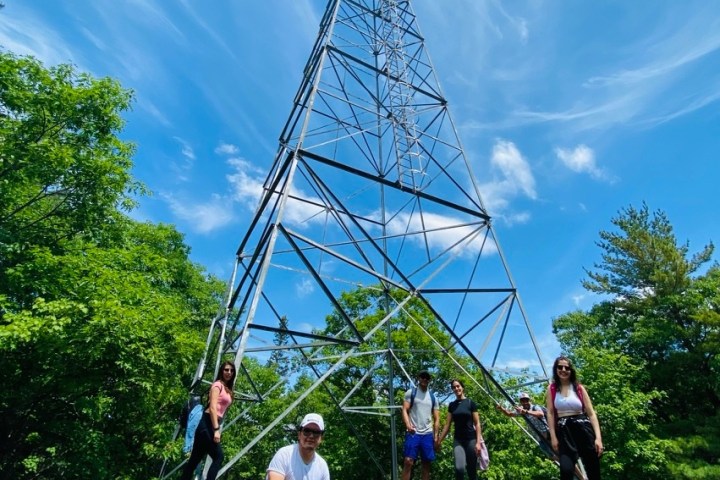 a group of people standing next to a statue of a man
