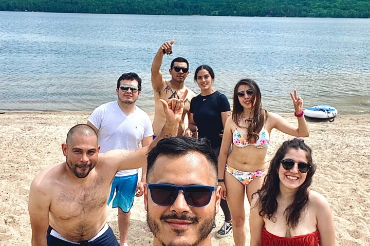 a group of people standing next to a body of water