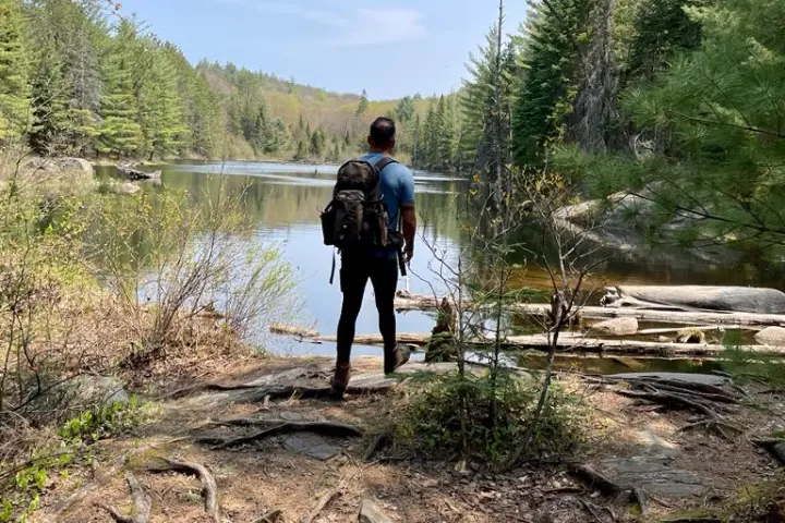 a person standing next to a river