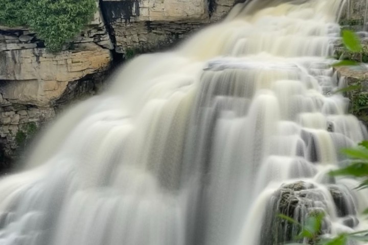 a large waterfall over some water