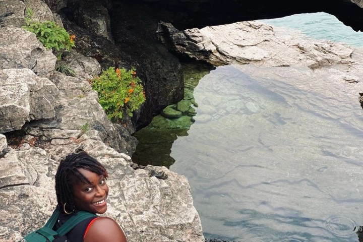 a person sitting on a rock
