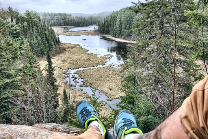 a man standing next to a river
