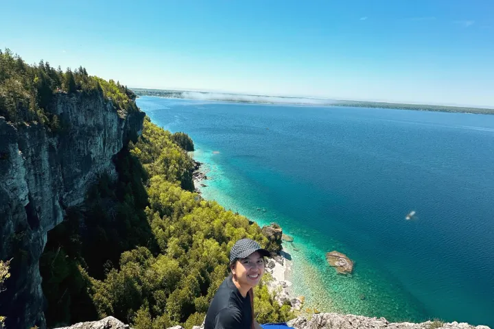 a man standing on a rocky beach