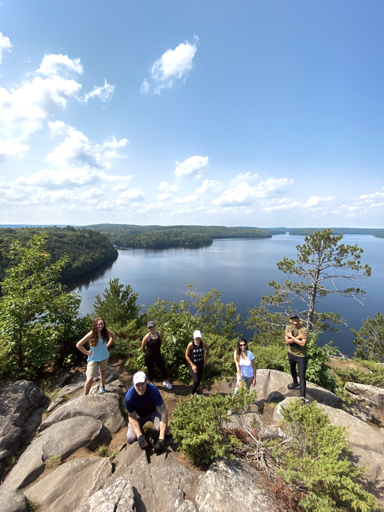 1C36C836-9223-4E0A-9BCE-740E604F0526_1_105_c a group of people on a rock next to a body of water