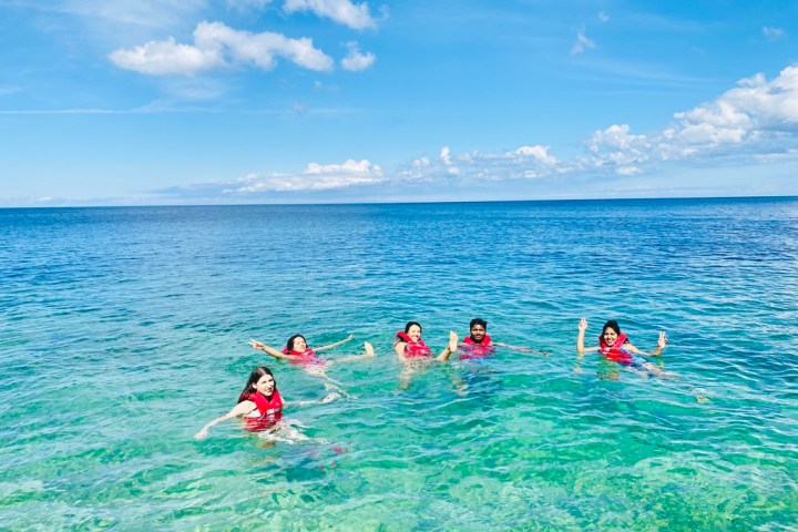 a group of people swimming in a body of water