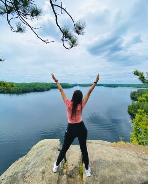 a person throwing a frisbee in a body of water