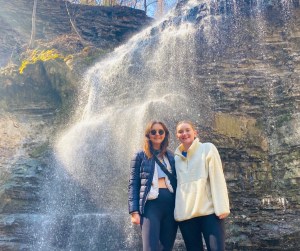 a person standing next to a waterfall