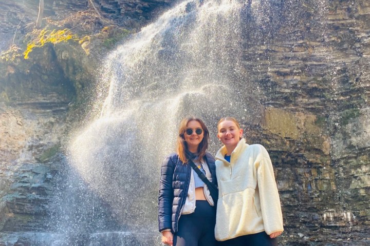 a person standing next to a waterfall