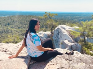 a person sitting on a rock