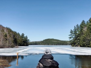 a person standing next to a body of water