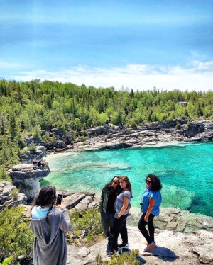 a group of people standing next to a river